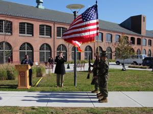 soldier carrying american flag at veteran's day event